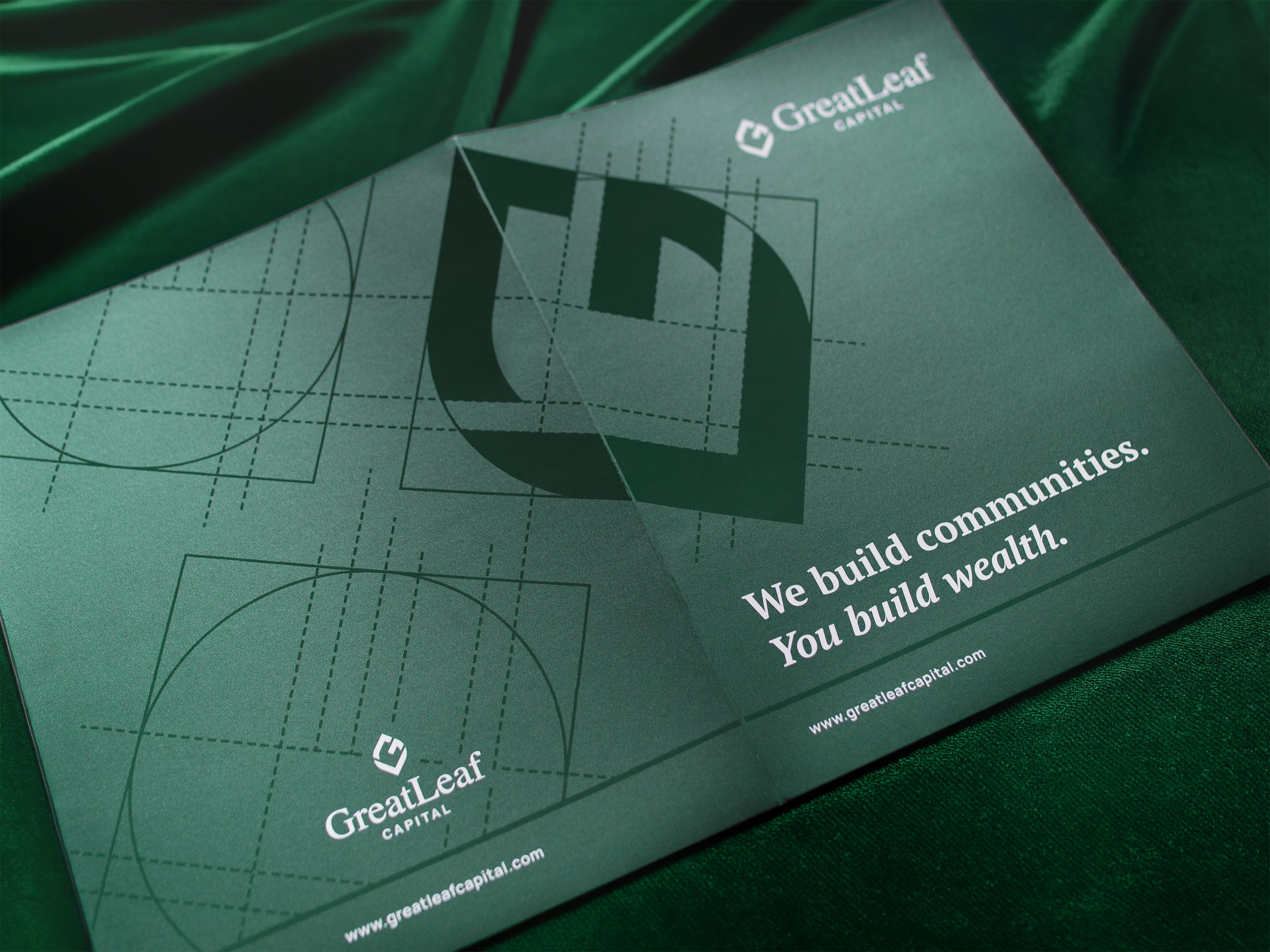 Photos of print collateral showcasing the GreatLeaf Capital branding. Materials include a branded folder, business cards and a notepad, all featuring predominantly rich green colors.
