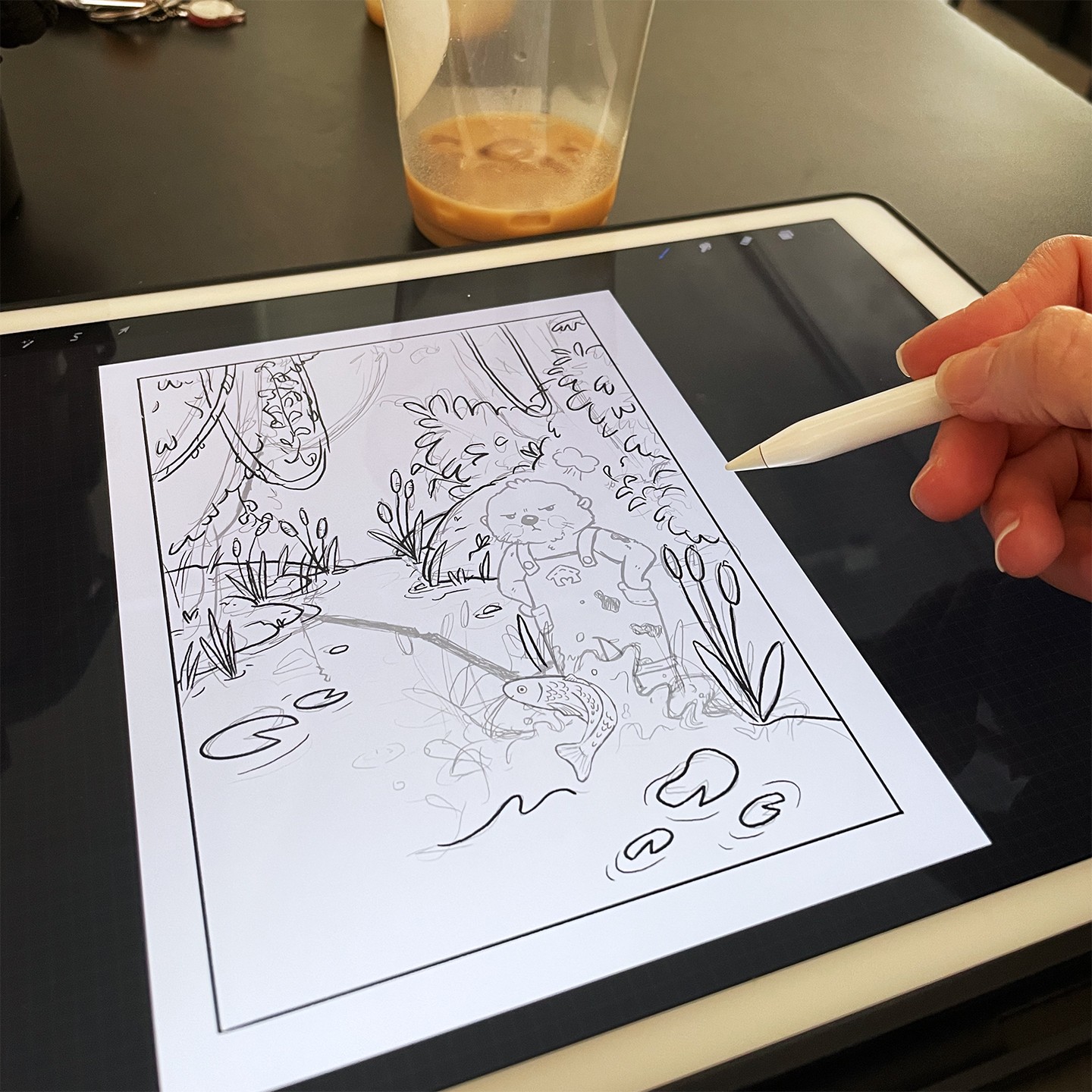 Photo of an ipad with a rough sketch of an angry otter standing by a river